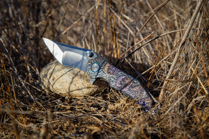 Decorative knife with a patterned handle on a natural background