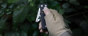 KS2E Multitool with one-hand deployment for easy access to tools like folding scissors, knife, and saw blade. Features a secure locking mechanism for safety during use.