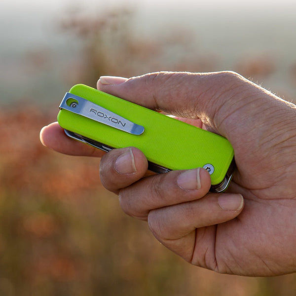 Hand Holding the new Neon green Flex Companion multitool