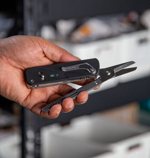 Hand holding the modular multitool, flex shears multitool with scissors on display