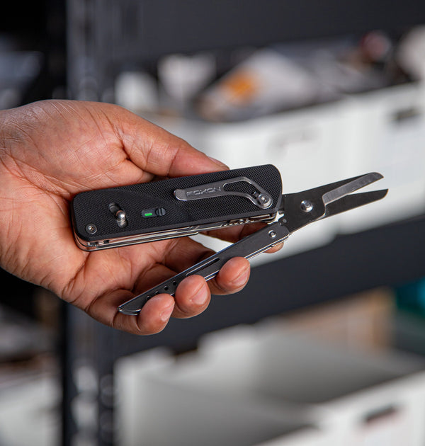 Hand holding the modular multitool, flex shears multitool with scissors on display