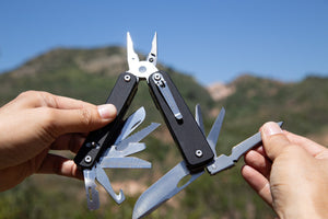 Hands holding a Flex Titan modular multitool outdoors