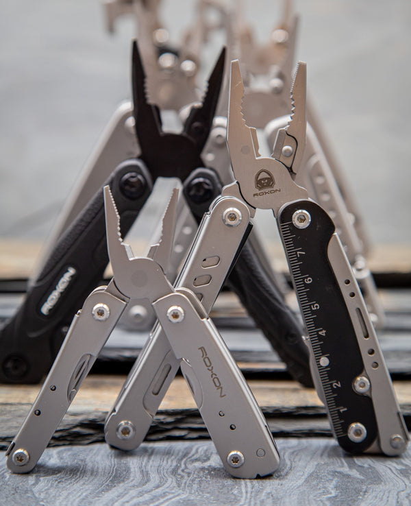 Multiple pliers based tools displayed against a stone background