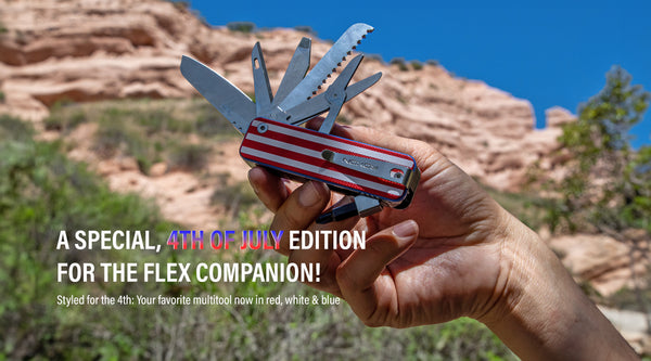 Hand holding the ROXON Flex Companion multitool with a red, white, and blue 4th of July special edition handle, fully opened, against a backdrop of red rock cliffs and blue sky.