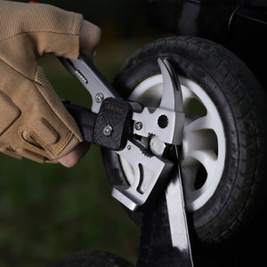 Multitool wrench being used to turn tire screws