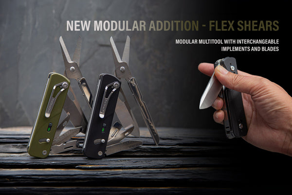 Hand holding a multi-tool with interchangeable blades against a dark background