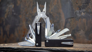 Multitools Roxon Flex System with various tools on a stone surface with a rustic background