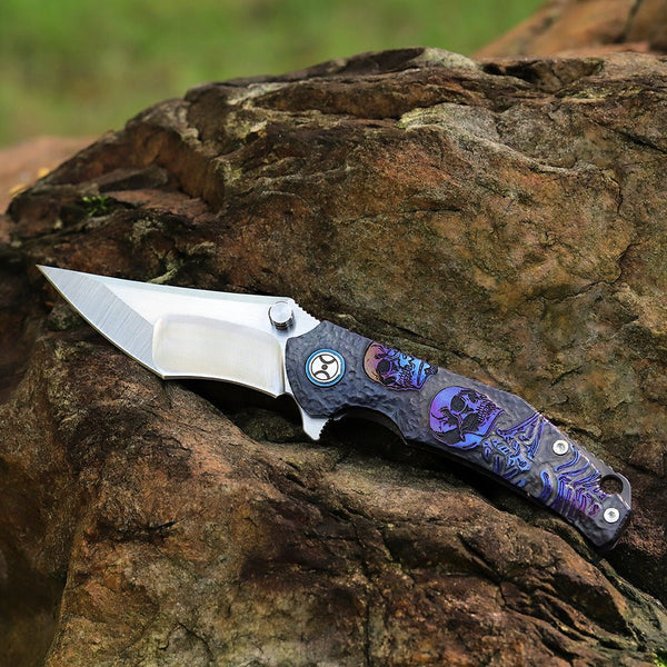 Folding knife with decorative handle on a wooden surface