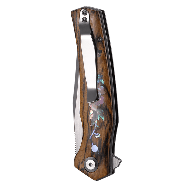 Wooden folding knife with floral inlay on a white background