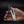 Hand holding a multi-tool with scissors on a black background