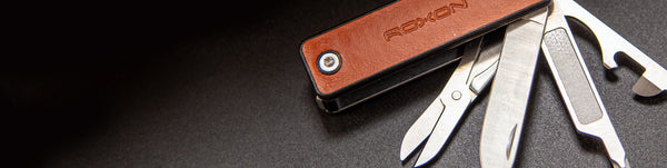 Multitool with leather case on a dark surface